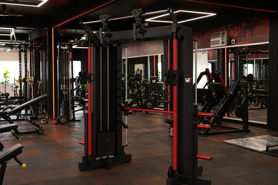 A working WTF gym floor — black and red machines under strip lighting, photographed in one of our operating gyms
