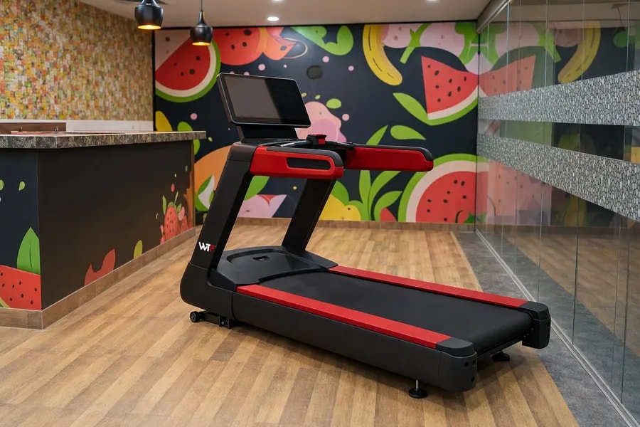 A working WTF gym floor — black and red machines under strip lighting, photographed in one of our operating gyms