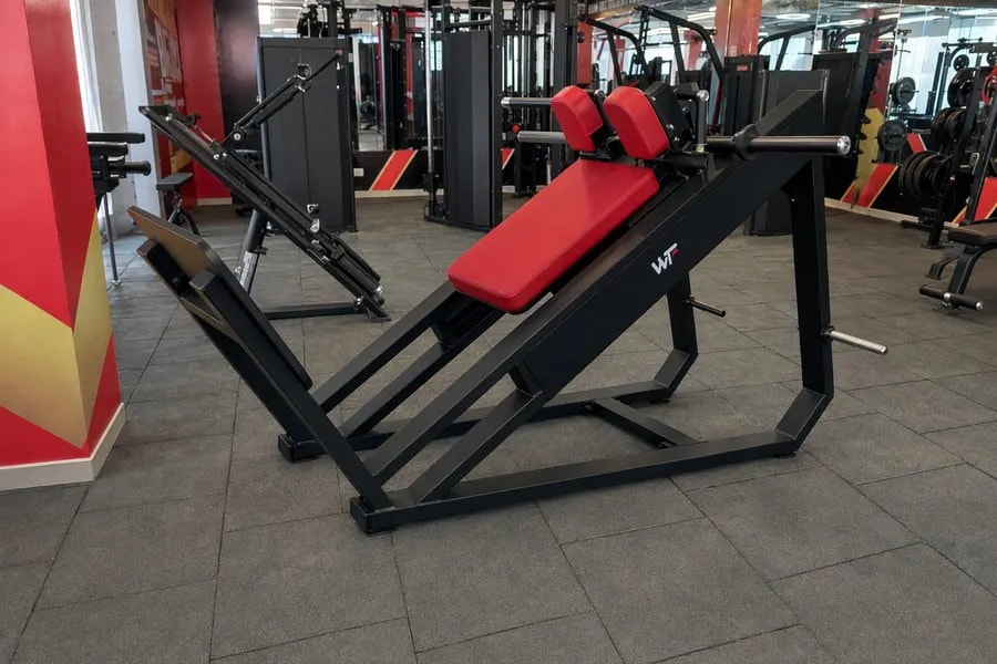 A working WTF gym floor — black and red machines under strip lighting, photographed in one of our operating gyms