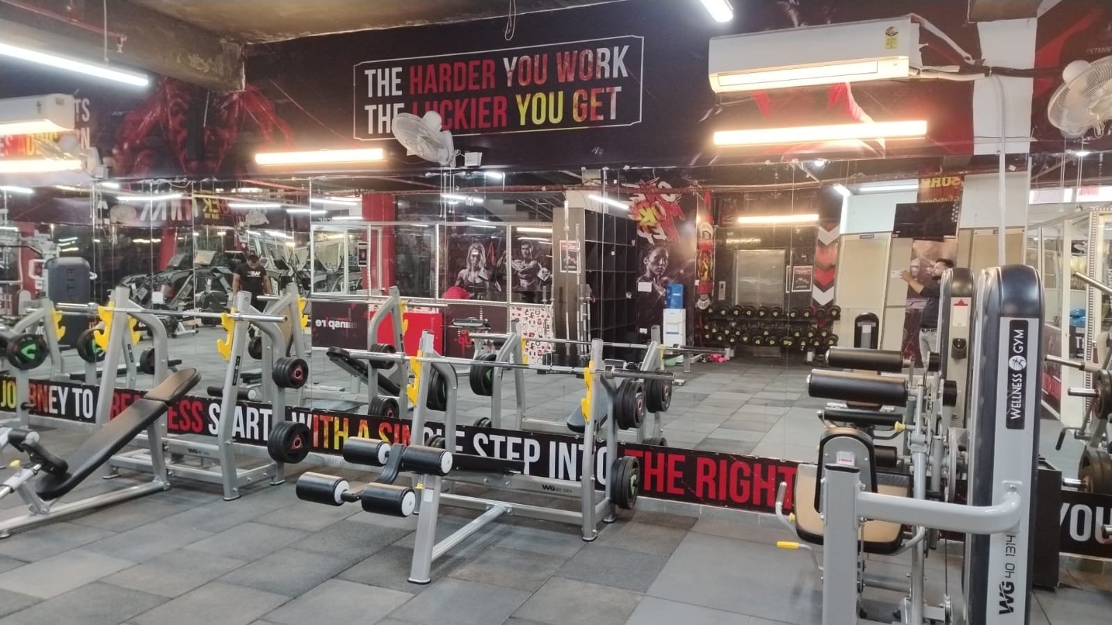 A wide strength floor with selectorized and plate-loaded machines at a WTF gym