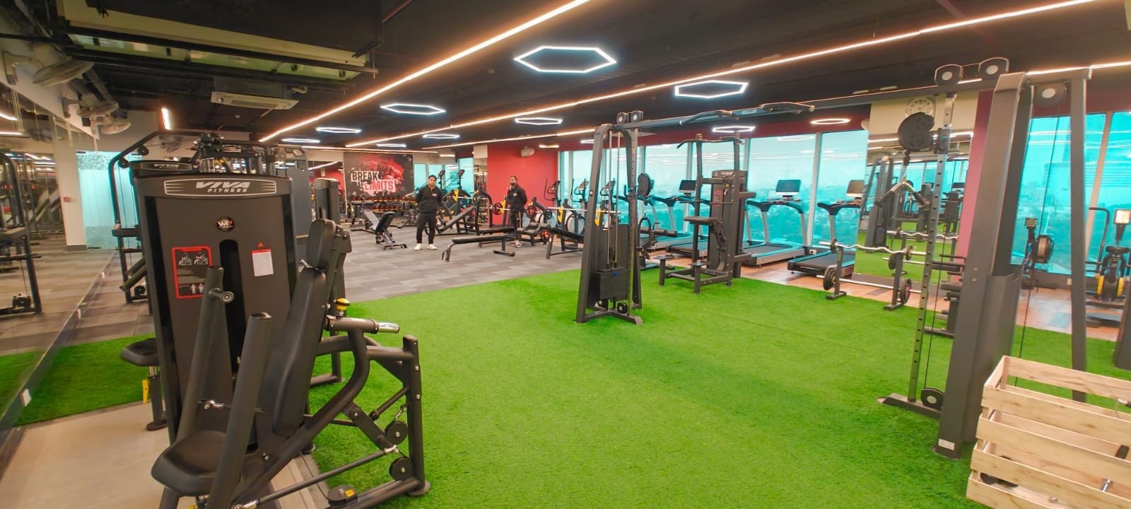 Strength machines and plyo boxes on the turf of a WTF gym