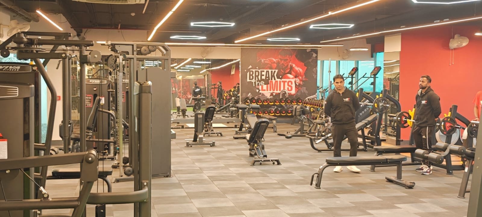 Members training on the strength floor of a WTF gym